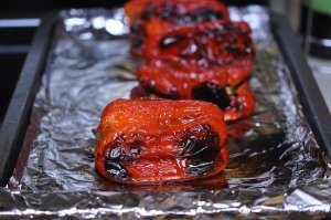 Roast peppers on a foil-lined baking sheet under the broiler until they're blackened on all sides.